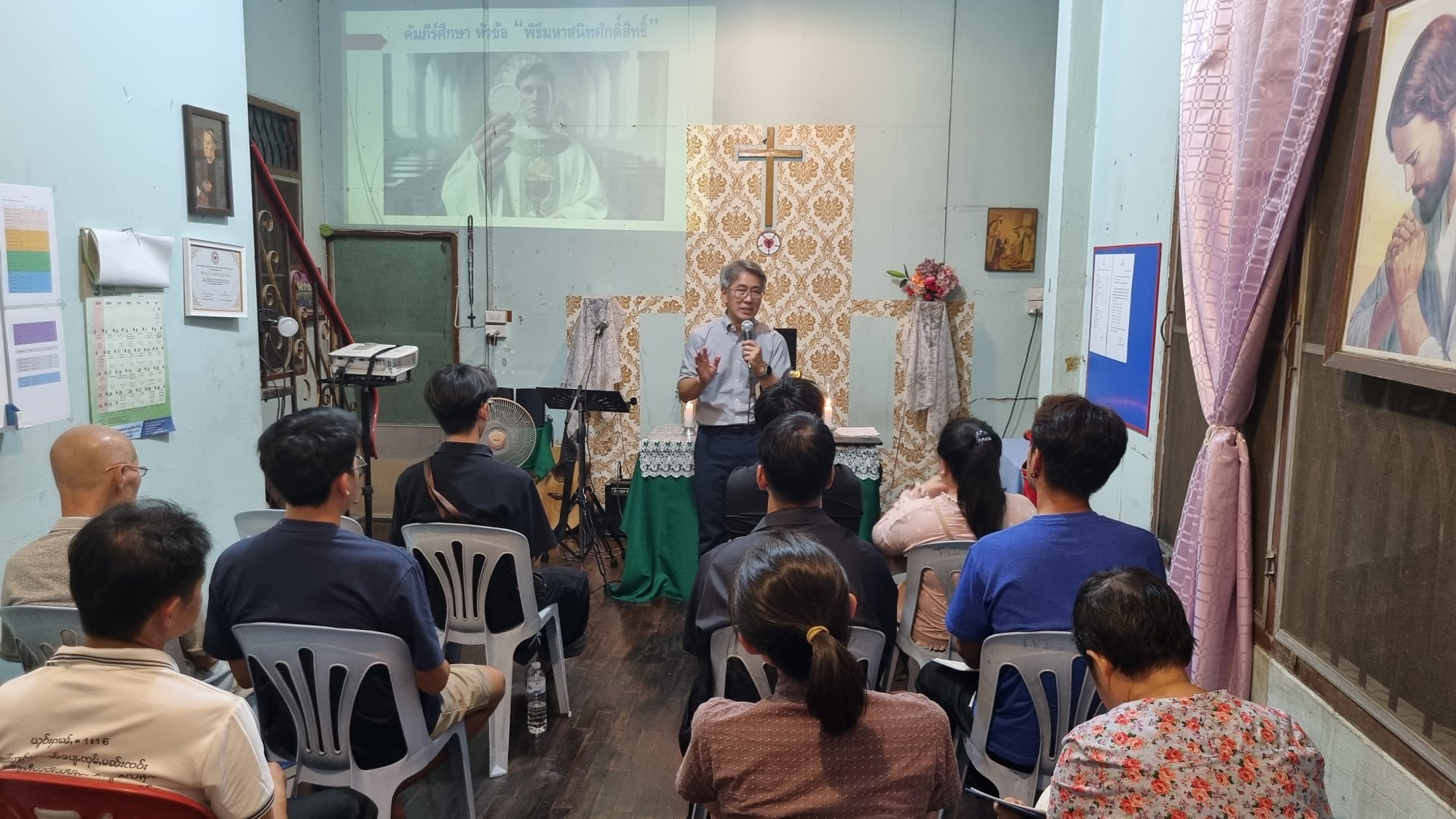 Pastor speaking to a group of people.
